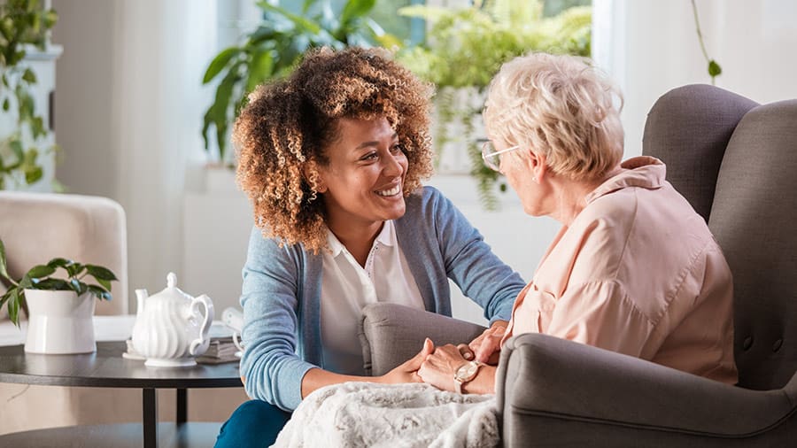 Long-term care provider spending time with an elderly person